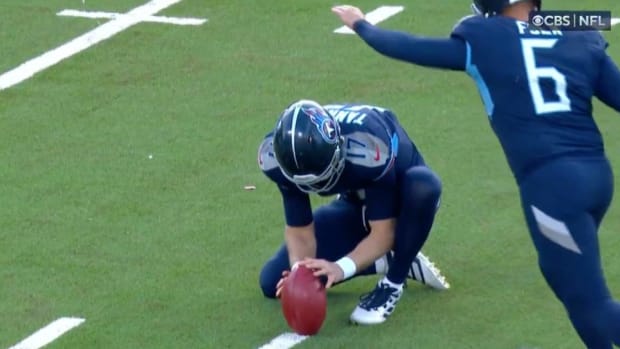 Ryan Tannehill holds an extra point for the Titans.